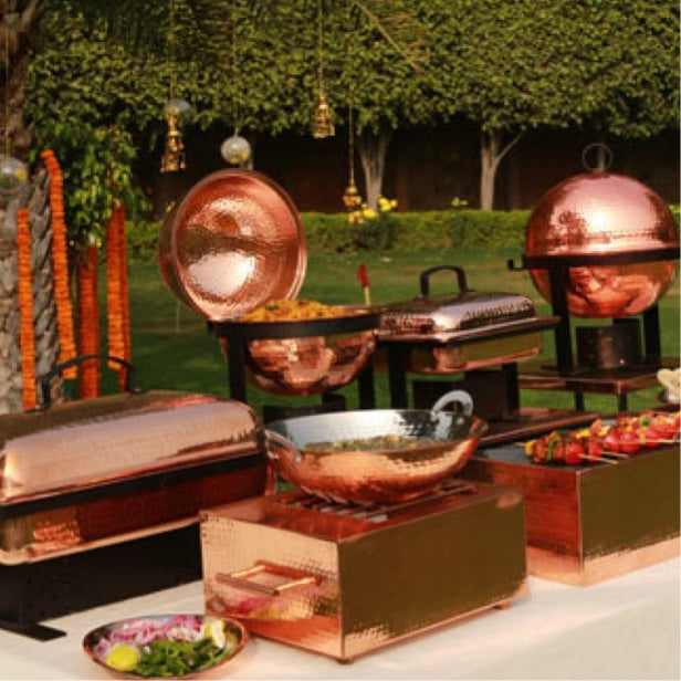 Copper buffet and chafer cooking rentals at an outdoor affair. 